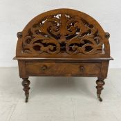 A 19th century figured walnut canterbury or magazine stand with pierced sections and base drawer