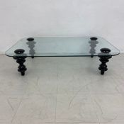 A retro styled coffee table with plate glass top on lacquered turned supports. H.30 W.120 D.80cm