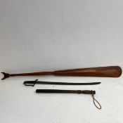 A 19th century hardwood paddle, inscribed, a 19th century short sword and a truncheon. L.134cm (