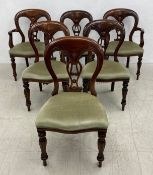A set of six Victorian style mahogany balloon back dining chairs including two carvers each having a