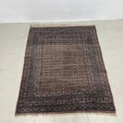 A Bokhara rug with repeating diamond motifs across the field within multiple stylised borders.