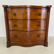 A mid 19th century mahogany serpentine fronted chest of three long drawers. H.99 W.107 D.56cm