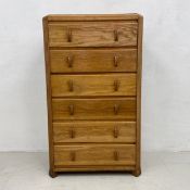 A mid-century Herbert Gibbs light oak tall chest of six short drawers with maker's label. H.119 W.69