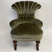 A Victorian child's (or doll's) nursing chair in buttoned upholstery on turned tapering legs. H.
