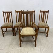 A matched set of five mid century oak dining chairs.