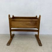 A C.1900 Continental walnut rocking cradle on stand. H.98 L.110cm (Signs of historic woodworm as