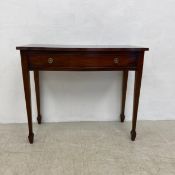 A Georgian style mahogany serpentine fronted console table fitted with frieze drawer on square