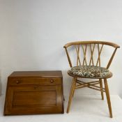 An Ercol beech Shalstone armchair and an Ercol desk top secretaire cabinet with locking mechanism to