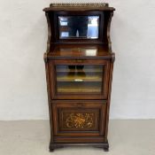 A late 19th century rosewood and inlaid music cabinet with brass galleried top and glazed