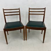 Two mid-century teak dining chairs by G-Plan with maker's stamp to the underside.
