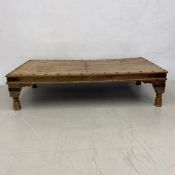 An Indian teak iron studded and bound low table. H.44 W.176 D.89cm