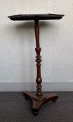A 19th century mahogany occasional or lamp table having an octagonal top raised on a turned stem