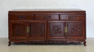 A contemporary Chinese hardwood sideboard having a rectangular top over an arrangement of three