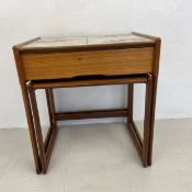 A nest of two mid-century teak occasional tables fitted with frieze drawer and inset ceramic tile