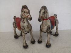 Two 1950s hand painted tin Mobo bronco horses with dapple grey finishes. H.75 W.67cm