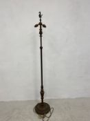 An early 20th century painted and gilt metal standard lamp with seahorse finial over a fluted stem