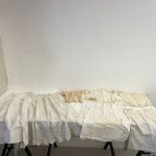 A miscellaneous collection of lace christening gowns, other children's clothes and pillow cases.