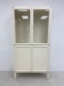 A 20th century Kovona style painted white metal medical cabinet of simple form with glazed cabinet