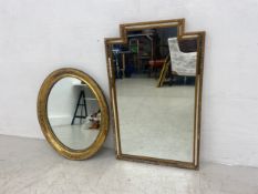 An early 20th century wall mirror with shaped top and gilt frame with glazed panels along with a