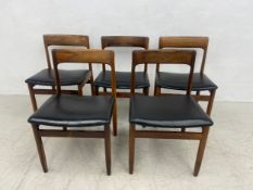A set of five mid-century Danish style dining chairs each having a curved back over a vinyl