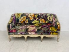 A 19th century carved and painted Gustavian sofa or settee having a square panelled back and