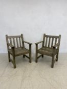 A pair of vintage weathered teak garden armchairs by Barlow, Tyrie Ltd. with maker's plaques. H.