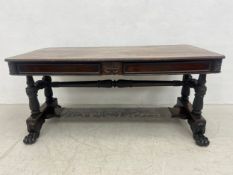 An early 19th century Anglo-Indian rosewood library table or writing desk having a rectangular top