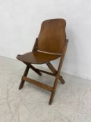A 20th century folding laminated plywood chair by American Seating Co., Grand Rapids, Michigan.