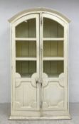 A 19th century French painted floor standing cabinet having a shaped and moulded pediment over two