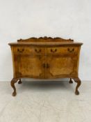 A 20th century Epstein style walnut sideboard having a shaped and carved gallery back with
