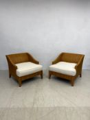 A pair of modern American woven rattan conservatory armchairs with fitted calico upholstered loose