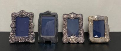 A collection of four silver hallmarked picture frames. 24x19cm Largest.