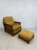 A vintage Ercol oak bergere armchair with matching footstool and maker's plaque. 90x79x90cm