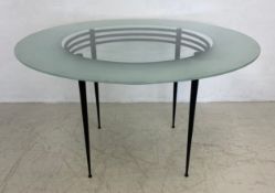 A 1980s 'Lunar' dining table having a circular glass top raised on a black bent metal substructure
