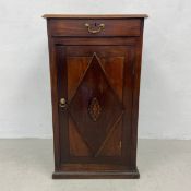 A 19th century mahogany cupboard or cabinet having a square thumb moulded top over a single frieze