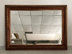 A vintage wall mirror with rectangular plate in a rope moulded gilt frame. 77x106cm