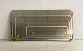 A contemporary retro style wall mirror of rectangular form with curved corners and an etched