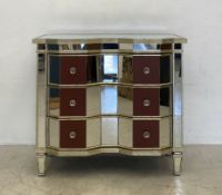 A vintage Hollywood Regency style chest or three long mirrored drawers having a bevelled and