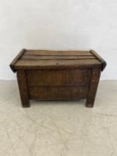 An 18th century oak Shepherds chest or coffer having a hinged three plank top over a geometric