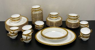 A Minton Buckingham pattern tea and dinner service for twelve place settings with gilt decoration