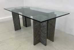 A contemporary brutalist style writing desk or dining table having a thick plate glass top raised on