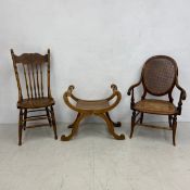 A carved oak piano stool or window seat, a 19th century caned beech armchair and a 19th century