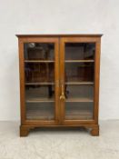A 19th century glazed mahogany bookcase having a moulded cornice over a pair of glazed door