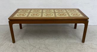 A mid century teak coffee table with inset ceramic tiled top. 42x113x52cm