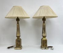 A pair of 19th century French painted and gilt metal table lamps each having a reeded ball finial