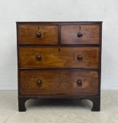 A 19th century mahogany chest of two short over two long drawers with turned handles raised on