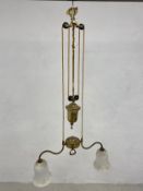 A C.1900 brass rise and fall ceiling light with brass weight and pulleys.
