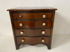 A Georgian mahogany and satinwood strung miniature serpentine fronted chest of four long