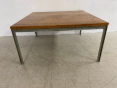 A mid-century coffee table in the style of Florence Knoll with square teak top raised on straight