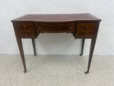 A 19th century mahogany writing table having a leather lined and feather banded top over a